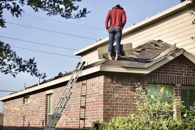 Professional roofer working on a residential roof in Moonachie